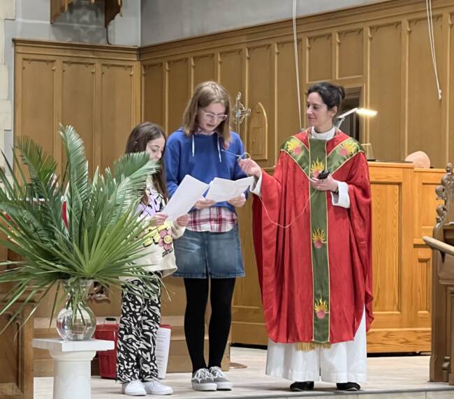 Kids relaxed service. 2 kids are reading something, while Rev. Irina is holding the recorder for them.