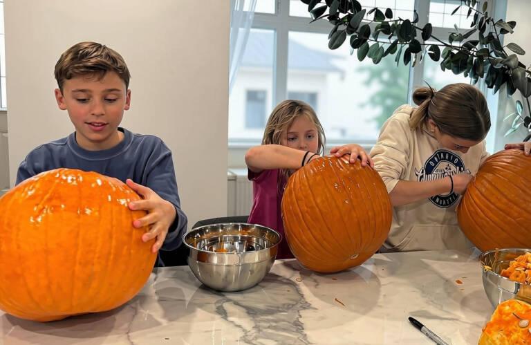 Kids carving pumpkins at a free family Halloween event in Toronto